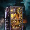 A detailed wooden bookshelf insert model of a pirate ship displayed within a dark, dramatic box against a stormy sea backgrou