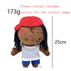 A plush doll with dark hair and a red hat, featuring a face design related to Eminem, XXXTentacion, and Frank Ocean.