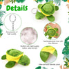 A handmade green and yellow stuffed sea turtle plush toy with a silver charm and fine stitching.