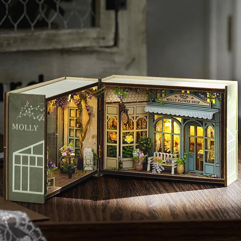 A wooden miniature dollhouse kit featuring a flower shop facade with detailed furniture and lighting elements.