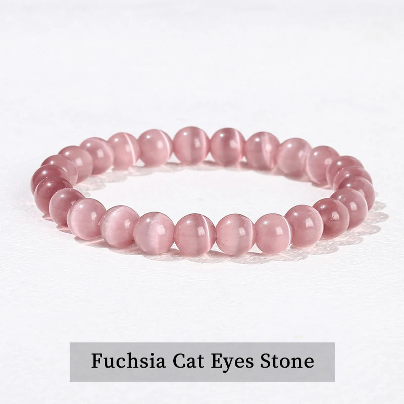 A bracelet made of pink quartz beads, resembling fuchsia cat eyes stone.
