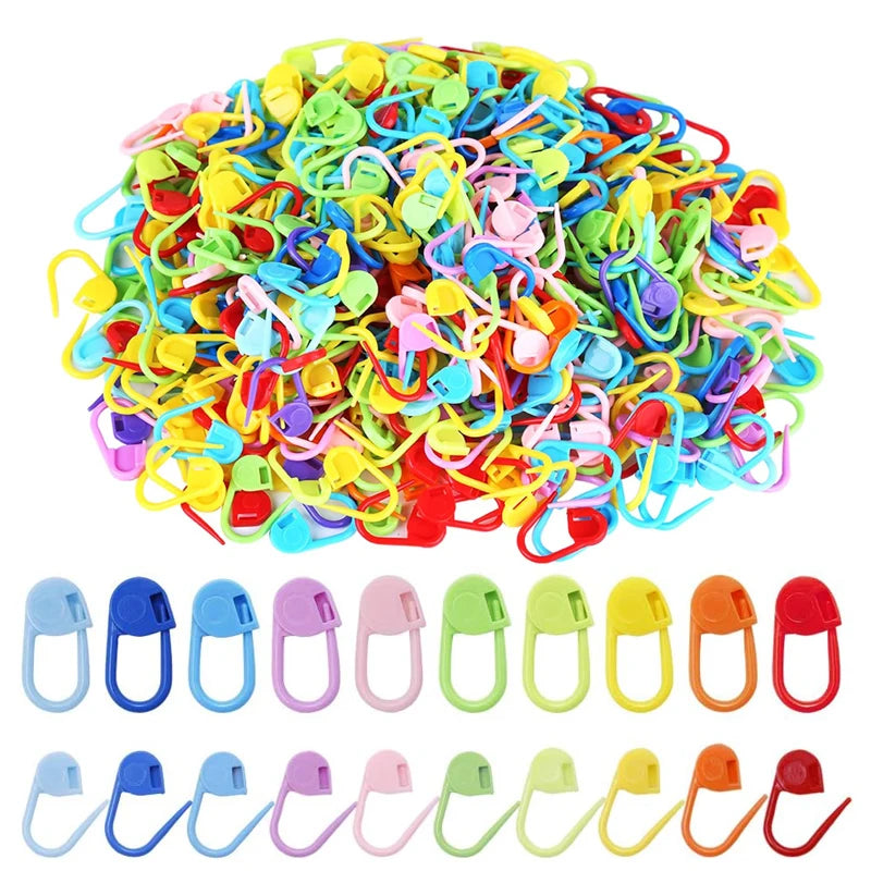 A pile of colorful locking stitch markers for knitting and crochet in various bright colors.