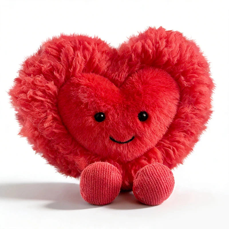 A bright red, fluffy heart-shaped plush cushion with a smiling face.