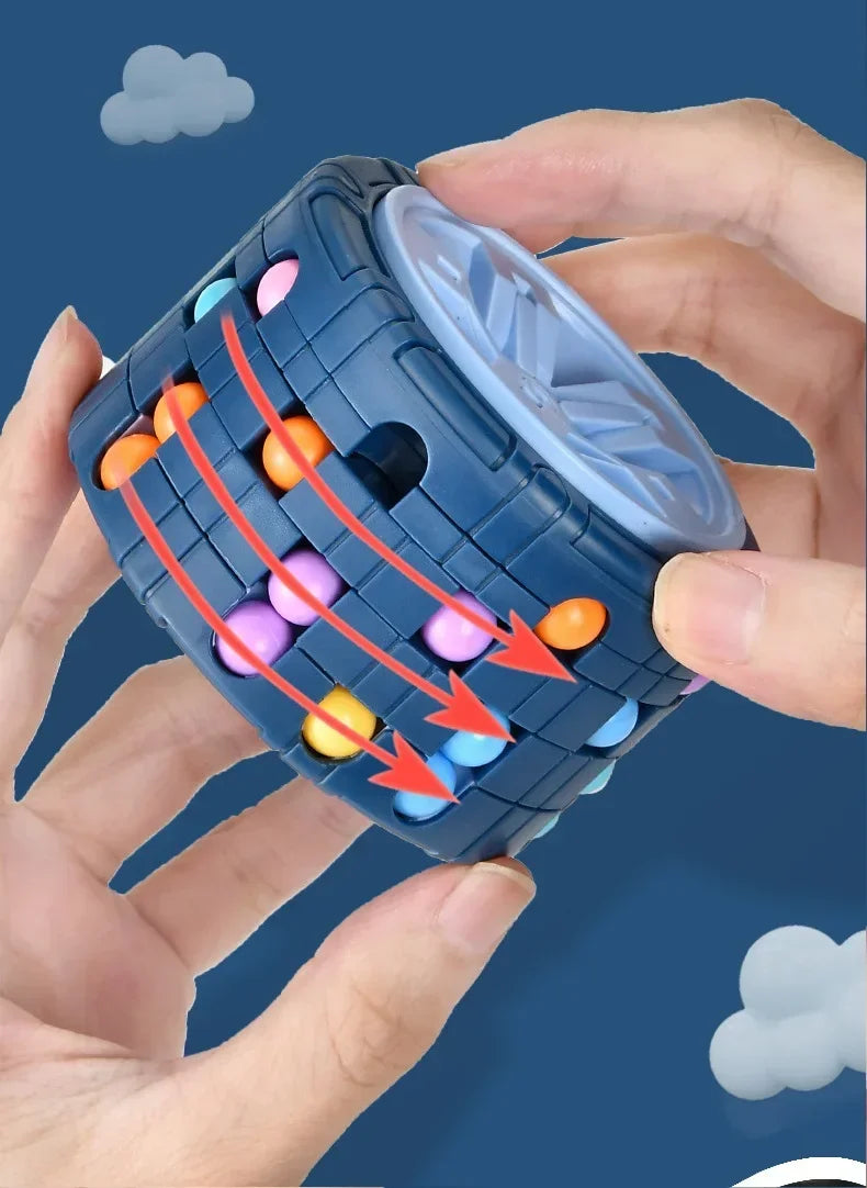 A hand holds a blue 3D rotating slide puzzle cube filled with colorful plastic balls.