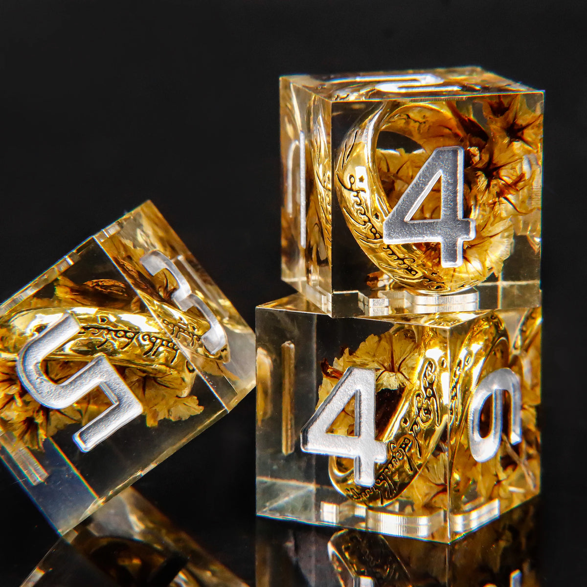 A set of resin dice featuring golden elven numbers inspired by Lord of the Rings