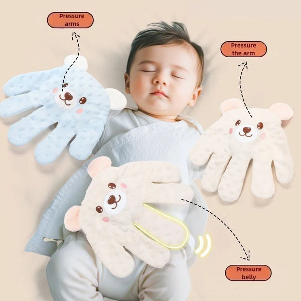 A baby is shown resting on a light background with three soft, fuzzy bear-themed pressure arms applied to the arms and belly.