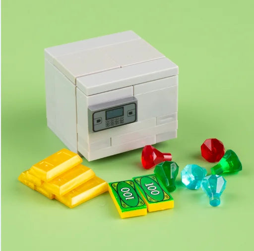 A white building block treasure chest set with gold and green glass coins on a light green surface.