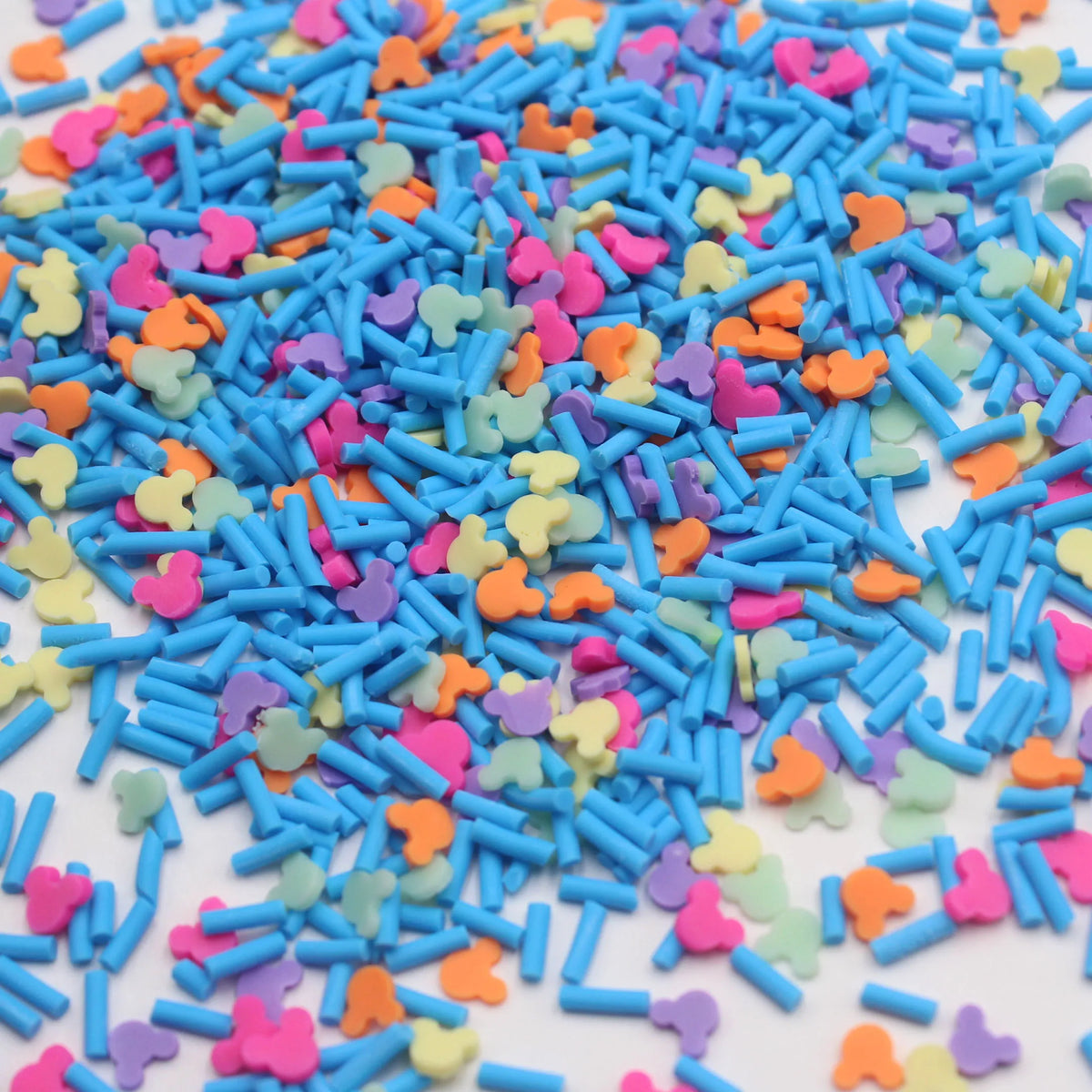 A pile of colorful polymer clay slices in various shapes and colors for slime and craft projects
