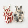 A pair of striped baby rompers in beige and terracotta with small bear decorations.