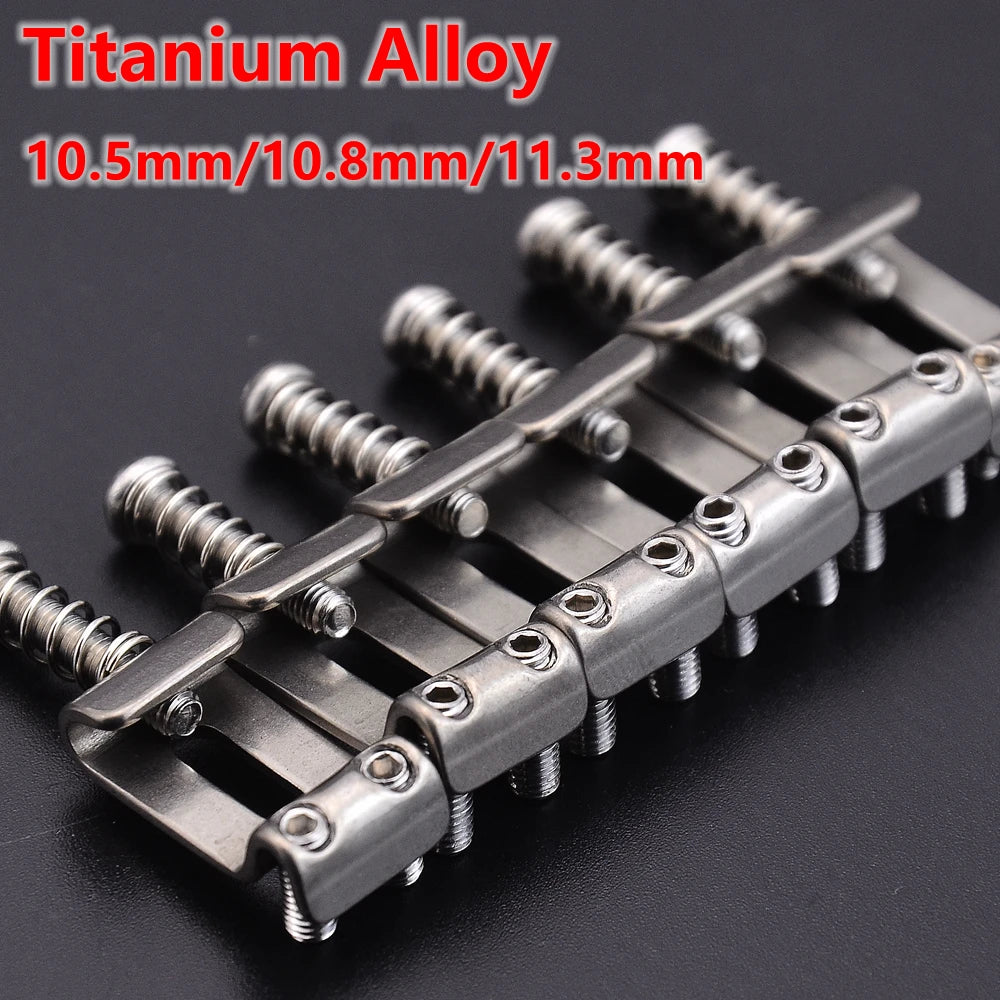 A set of titanium alloy electric guitar bridge saddles for ST models, showing various thicknesses.