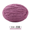 A ball of purple chunky chenille yarn used for hand knitting projects.