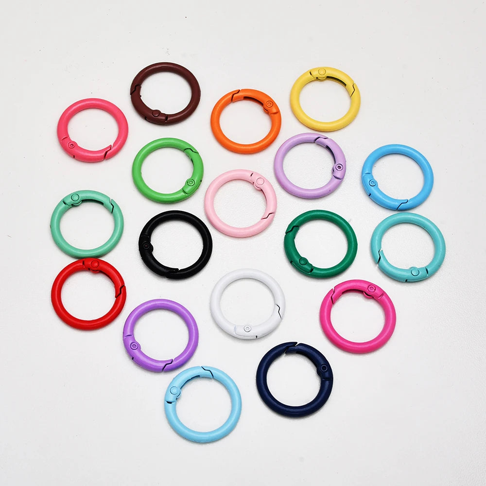 A collection of colorful alloy snap hook keychain clips in various colors like pink, orange, green, and blue.