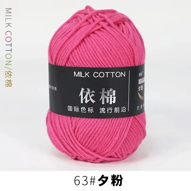 A ball of pink milk cotton yarn labeled with Chinese characters and a size tag.