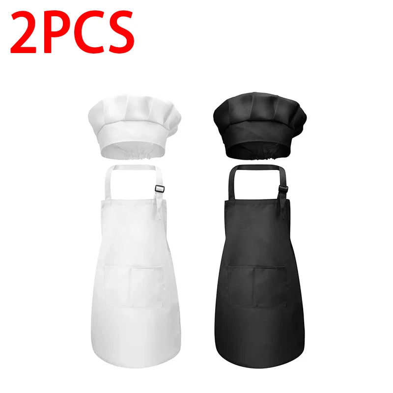 A set of two black chef hats and aprons for kids