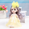 A 17cm articulated princess doll with long gray hair and a yellow dress, sitting next to a white box.
