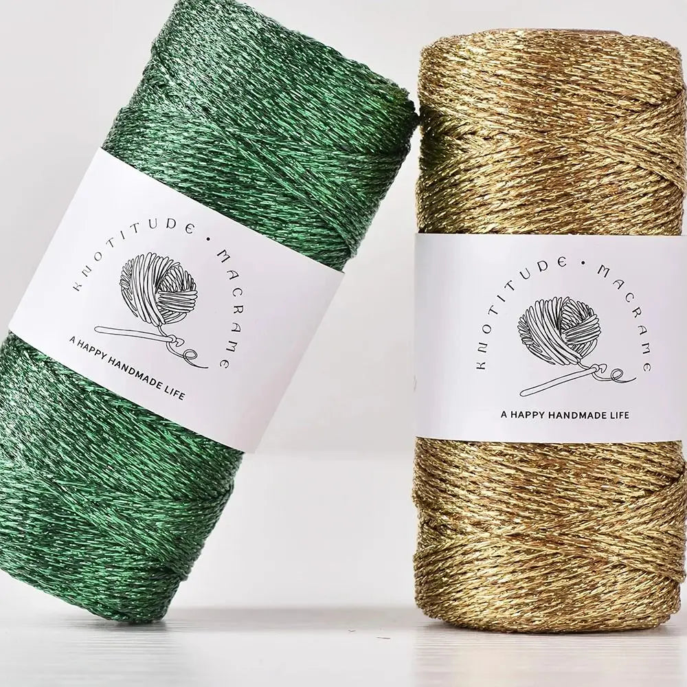 Two spools of metallic gold and green macrame yarn for knitting and crochet