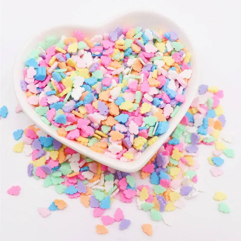 A heart-shaped dish filled with colorful polymer clay sprinkles for slime decor and DIY craft accents