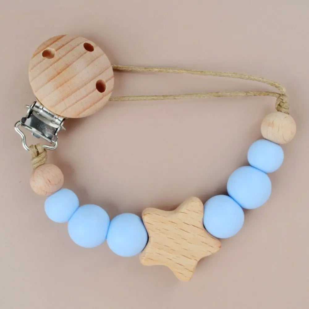 A wooden pacifier clip featuring silicone beads in light blue and natural wood tones.