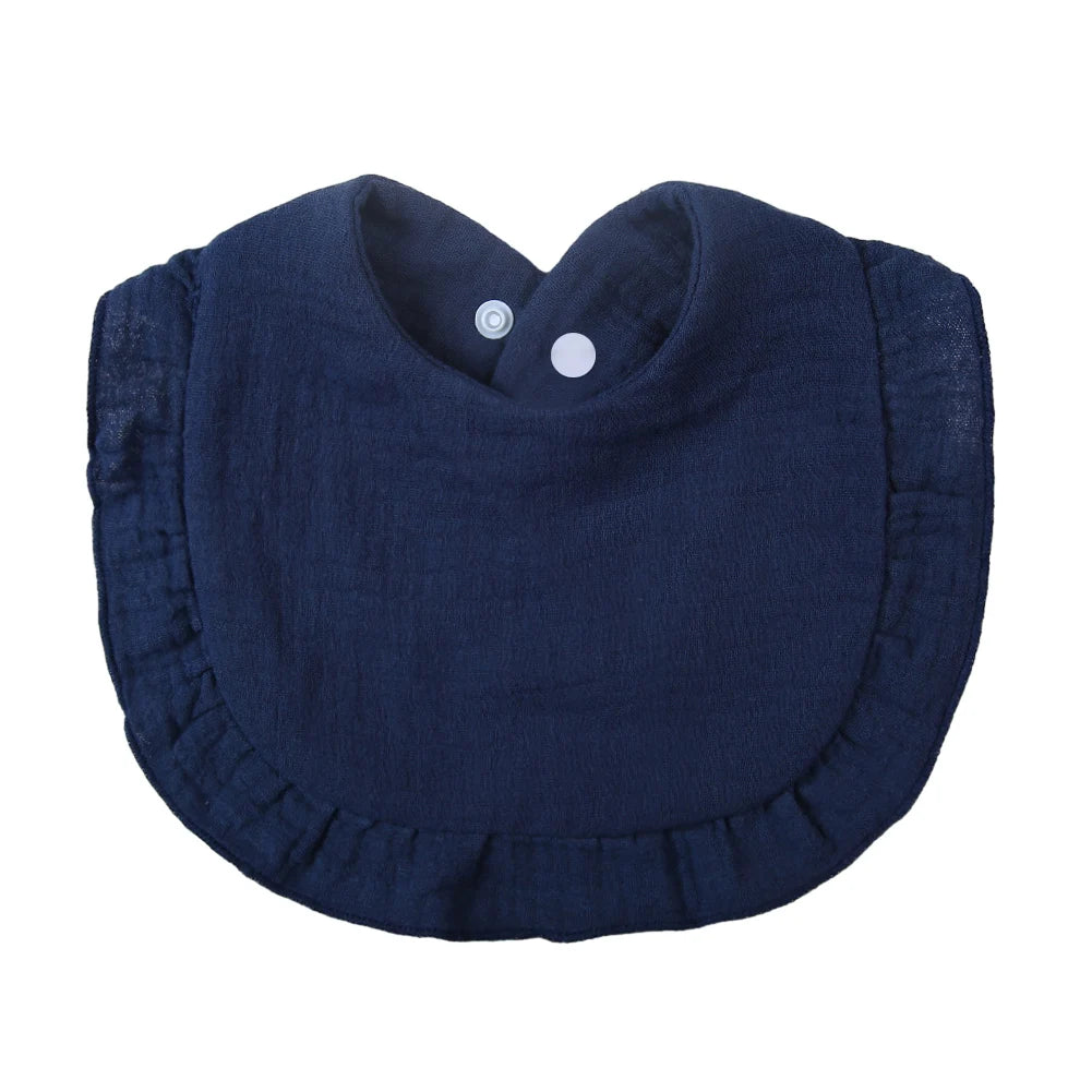 Navy blue ruffled muslin cotton baby bib with an adjustable snap closure