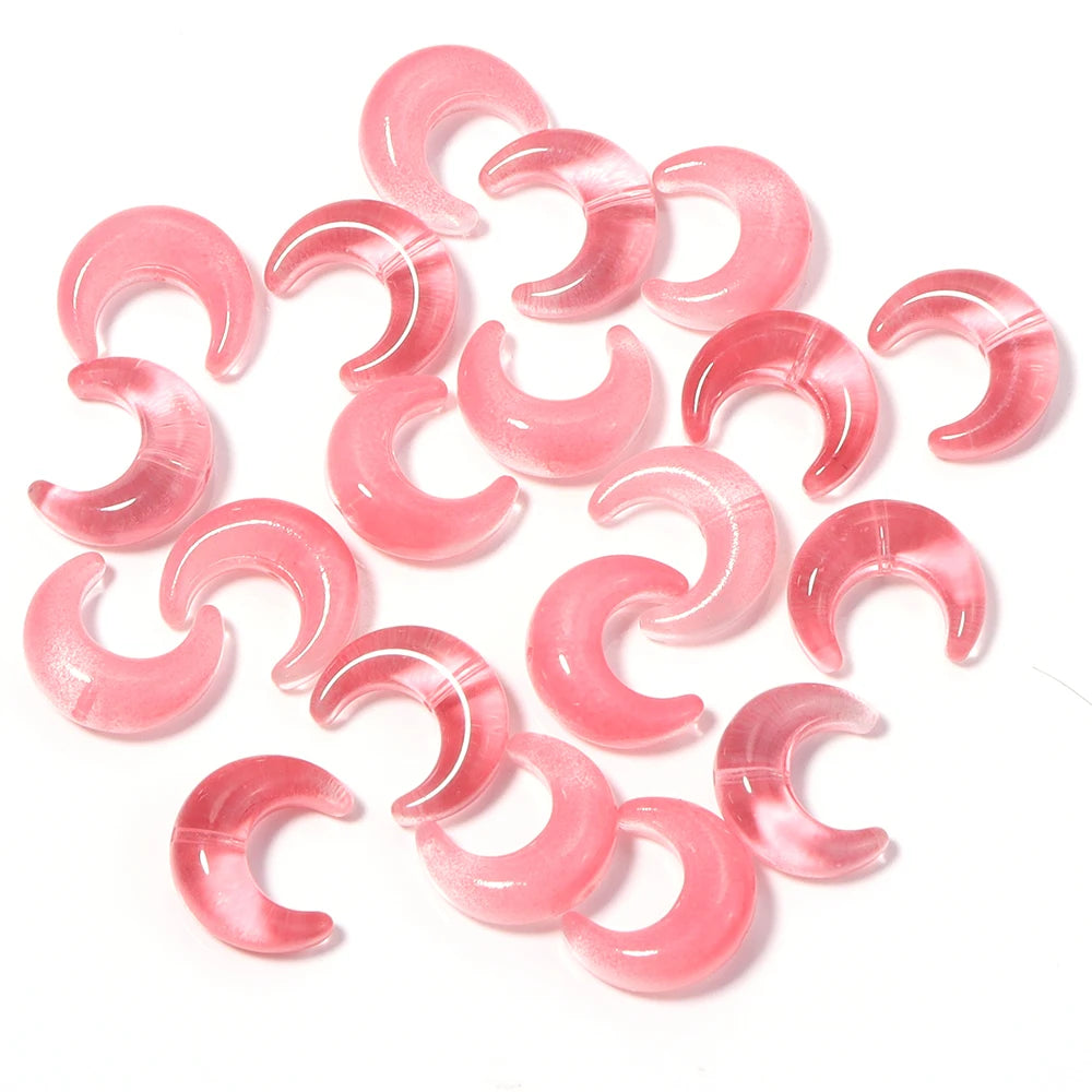 A collection of pink moon-shaped glass beads for DIY jewelry making