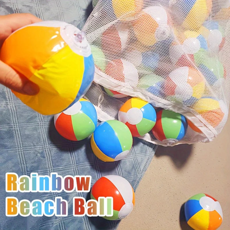A hand holds a rainbow beach ball next to a clear mesh bag filled with colorful inflatable beach balls.