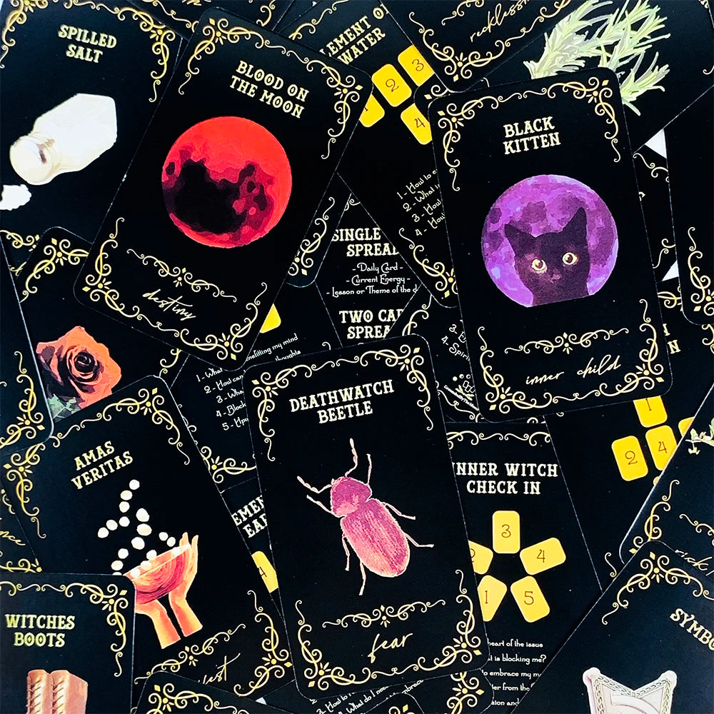 A collection of black oracle cards featuring mystical symbols and illustrations for divination.