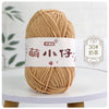 A ball of light brown chenille yarn labeled with Chinese characters for knitting and crochet.
