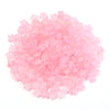 A pile of pink and clear star-shaped acrylic beads for jewelry making