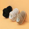 Pair of tan and black cozy leather winter boots for toddlers with anti-slip rubber soles