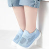 A pair of light blue breathable mesh slip-on sneakers for toddlers resting on a white surface.