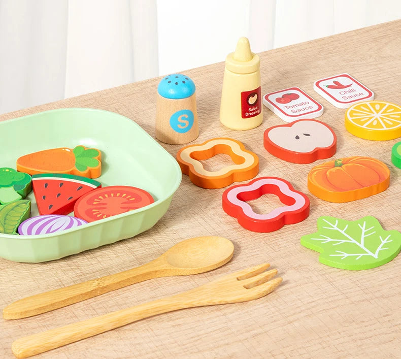 A wooden salad pretend play food set featuring various colored fruits and vegetables like carrots, tomatoes, and cucumbers.