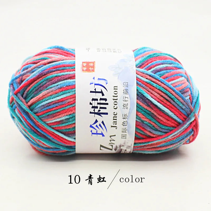 A ball of bright multi-colored yarn, featuring pink, blue, and red threads, labeled as Zun Jane cotton yarn.
