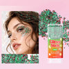 A tube of Glitter Stick with green and red sparkling sequins next to a model applying the glitter on her eye.