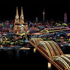 A nighttime cityscape featuring prominent gothic spires, modern buildings, and a large arched bridge illuminated in warm tone