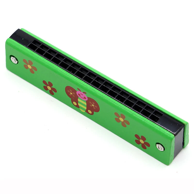 A green wooden harmonica with a black frame and a cartoon animal design featuring flowers and a bee.