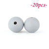Two round, white silicone beads with a hole are shown against a white background.