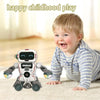 A happy toddler is playing with a white and gray Diigobot spinning music dancing robot on a light-colored floor.