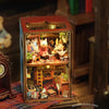 A wooden miniature dollhouse kit featuring detailed interior scenes and furniture.