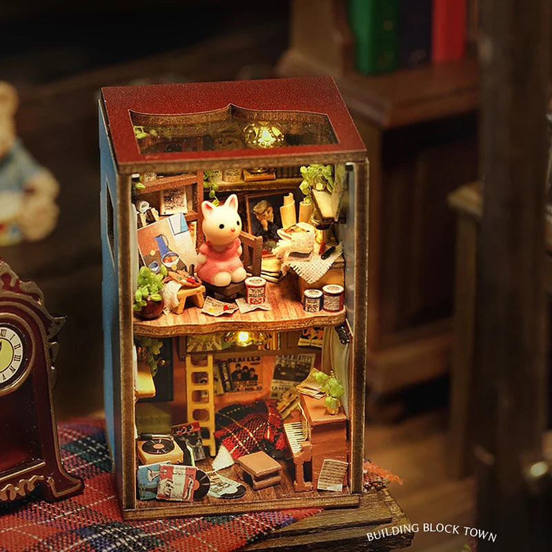 A wooden miniature dollhouse kit featuring detailed interior scenes and furniture.