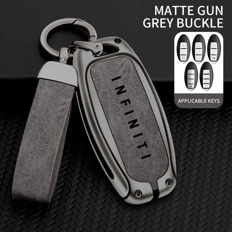 A matte grey buckle key case cover with a silver metal loop and multiple applicable keys displayed on a black textured surfac