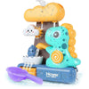 A bright teal dinosaur bath toy with a yellow tail is shown spraying water from a cardboard cloud structure.