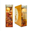 A DIY book nook kit featuring a detailed landscape diorama with LED lighting and a dust cover.