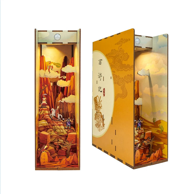 A DIY book nook kit featuring a detailed landscape diorama with LED lighting and a dust cover.