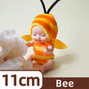 A small reborn baby doll with an orange and yellow striped hood and yellow wings.