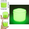 A clear jar of glow-in-the-dark crystal slime with neon green contents, shown next to a hand and a measurement guide.