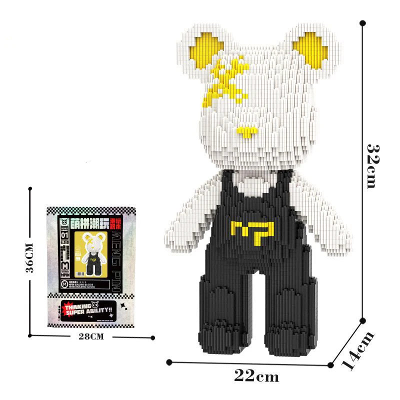 A white bear figure made of micro building blocks with yellow accents, shown next to a measuring tape.