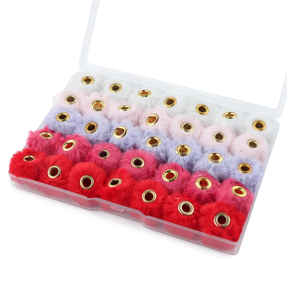 A clear plastic container filled with 35 plush fur pom pom beads in various colors like pink, purple, and red.