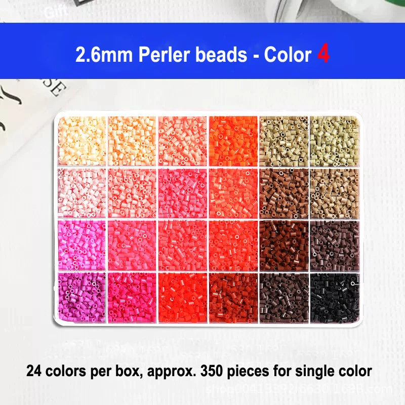 A display of 24 colors of 2.6mm perler beads in a box, showing various shades of red, pink, and brown.