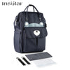 A navy blue waterproof diaper backpack with a removable changing mat and stroller straps.