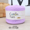 Purple 100% cotton yarn in a skein, labeled for knitting and crochet projects.